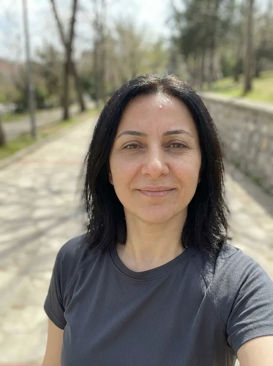 Original selfie input — woman in a gray T-shirt on an outdoor path